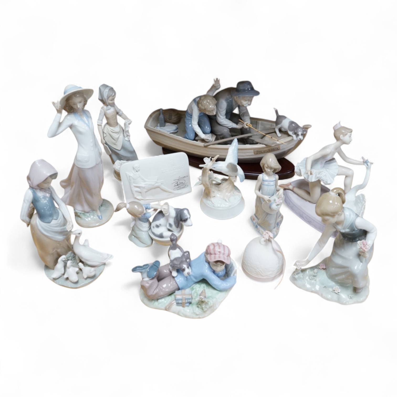 A Lladro fisherman group, nine other Lladro models and two others, similar. Fisherman group 40cm wide. Condition - generally good